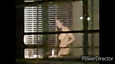 Hot young girl in the hotel window