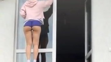 Young hot teen cleaning windows
